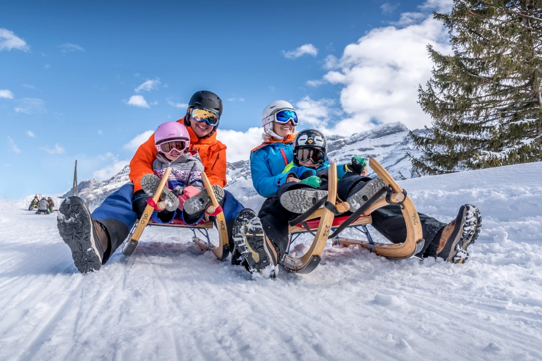 CTA Luge a Family Poses for a Photo on the Sled Run in Les Diablerets