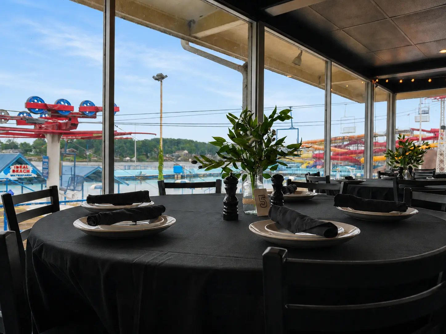 A table set for family-style dining in Papa Geno’s Skyroom with views of Indiana Beach