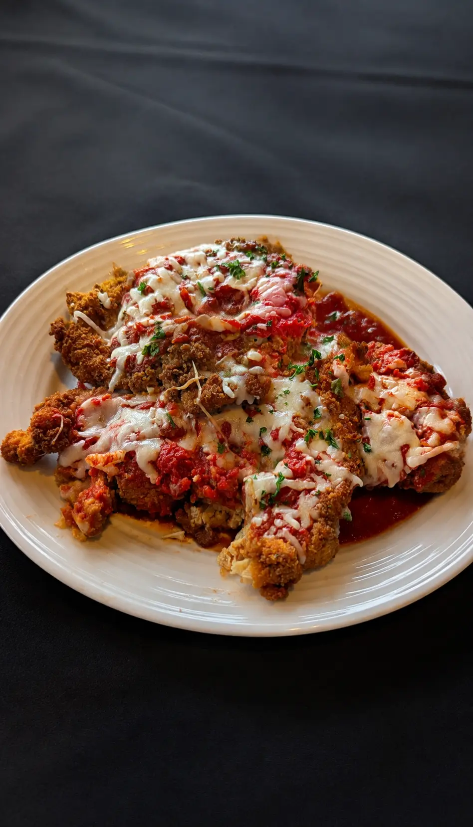 Papa Geno’s family-style chicken parmigiana with marinara and melted cheese